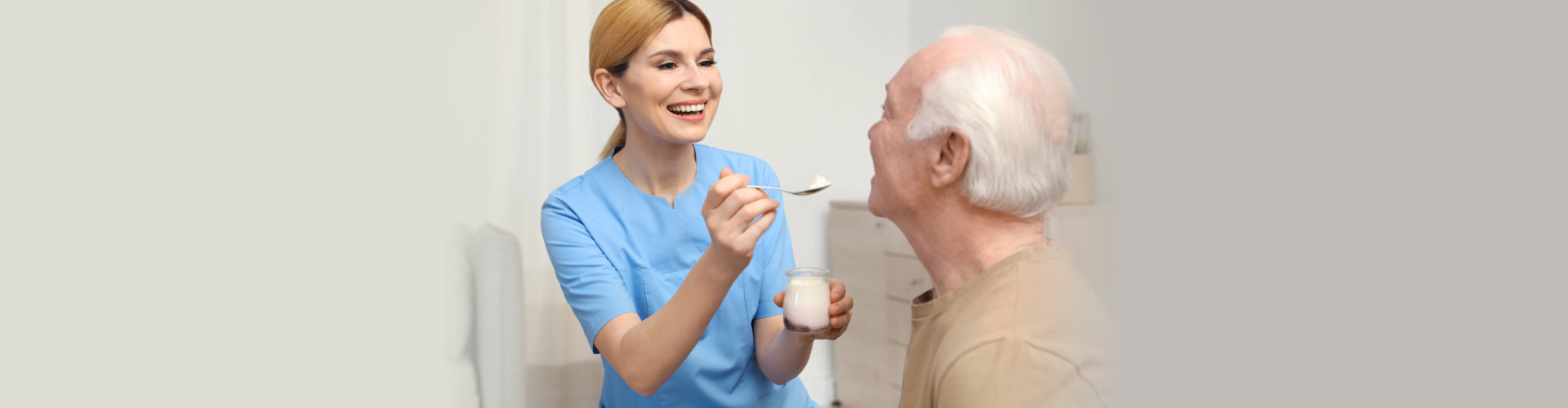 caregiver feeding the elderly